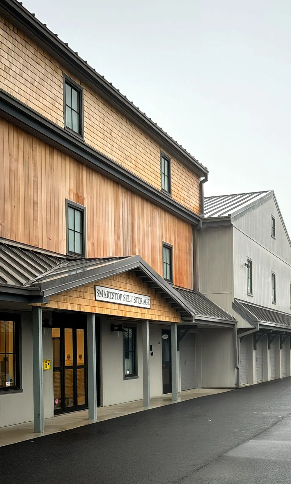 A multistory SmartStop Self Storage facility with natural wood siding.