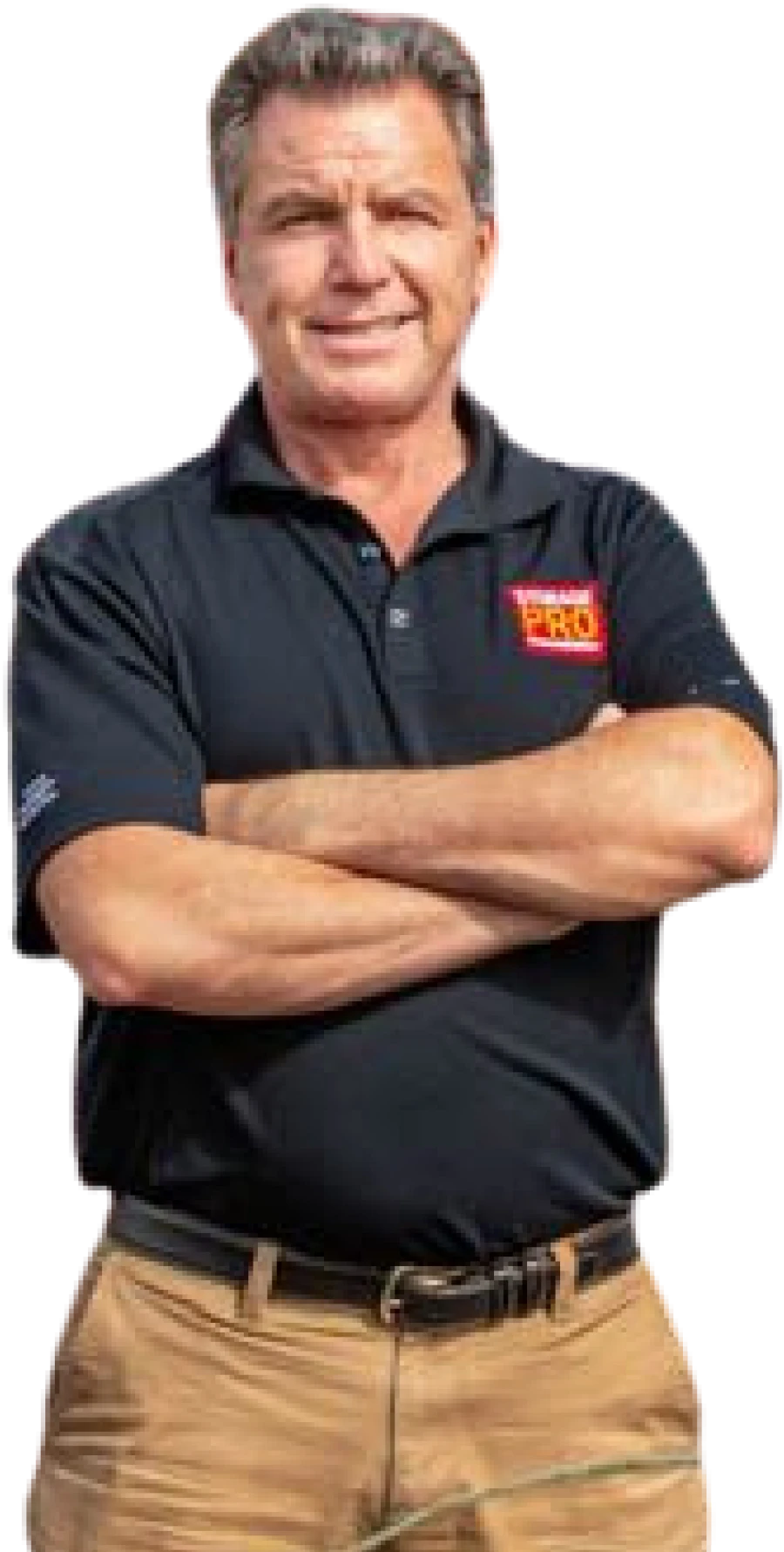A smiling man stands with his arms crossed wearing khaki pants and a black polo shirt with a "Storage PRO" logo on the chest.