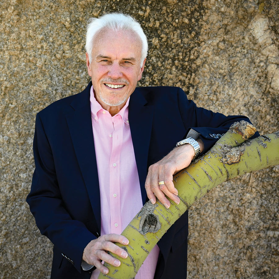 Mike Schofield leaning against a tree branch.