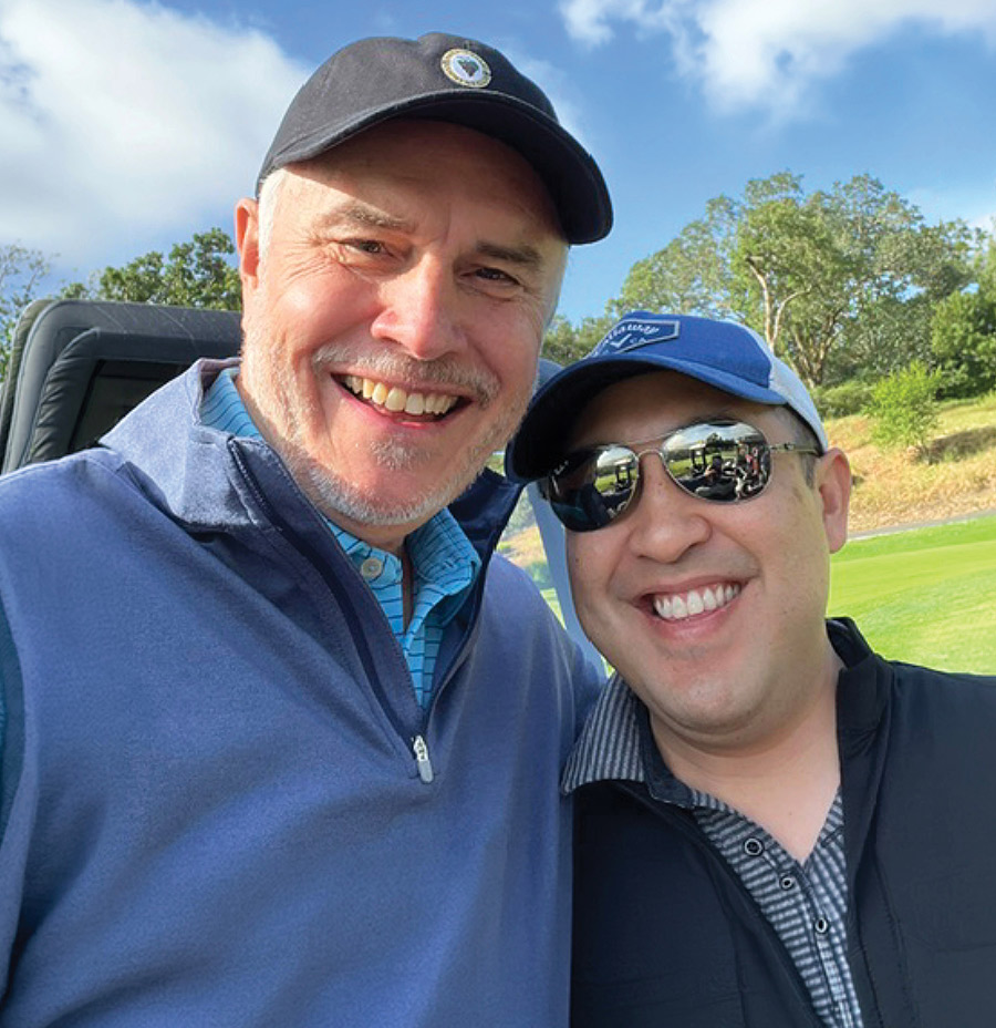 Mike Schofield and Mike Gong at a golf tournament.