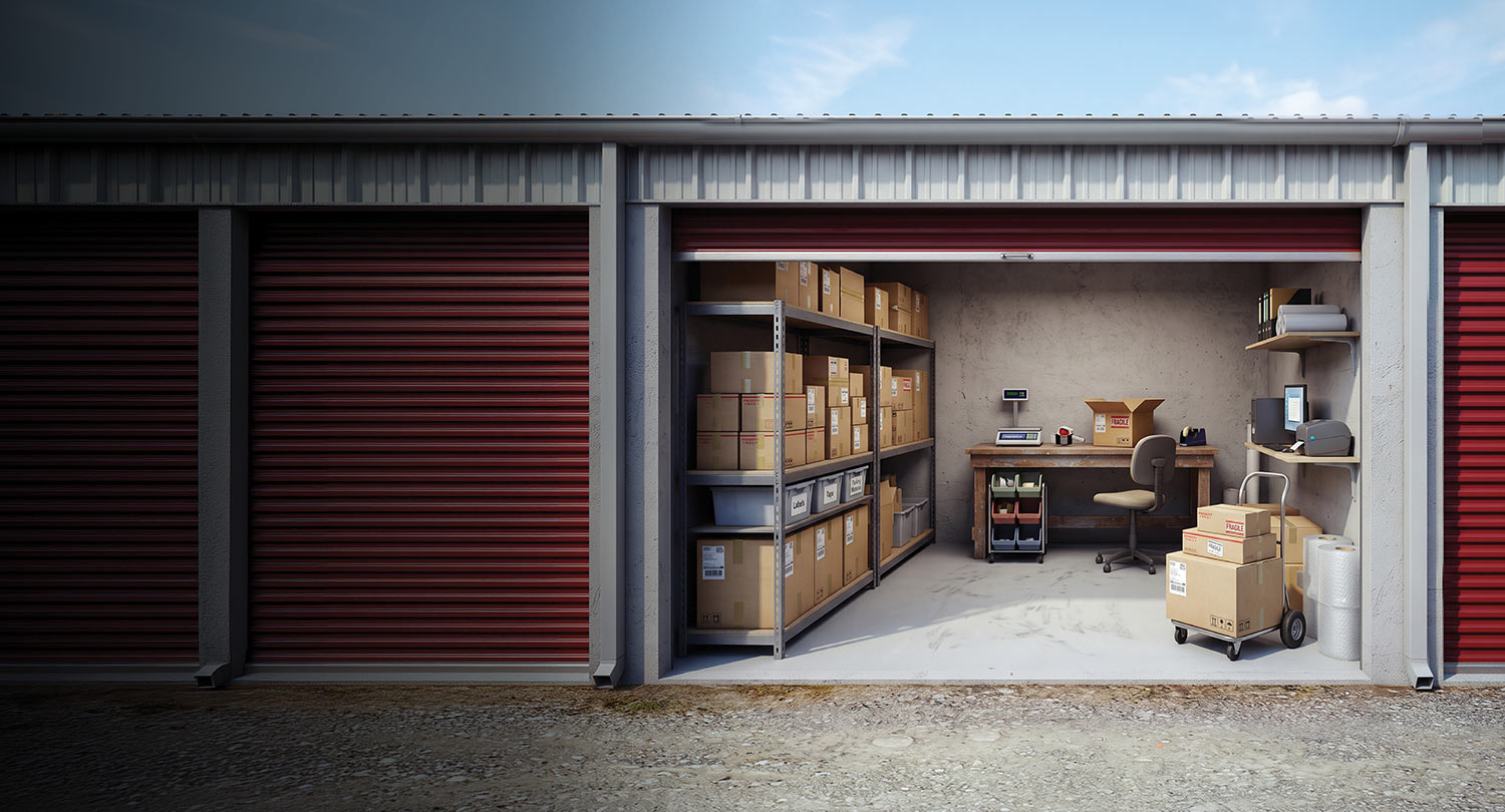 Self-storage unit configured as a workspace with shelves, desk, computer, and boxes.