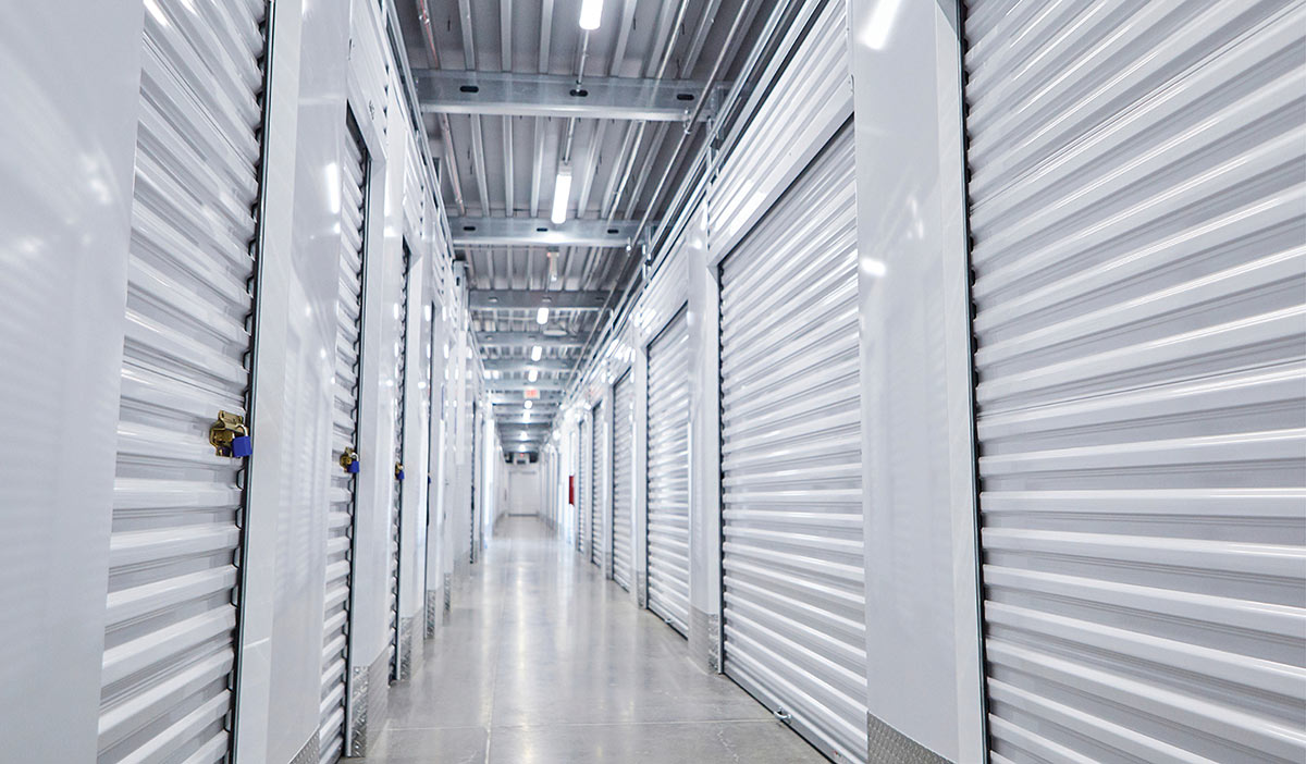 Interior hallway with white roll-up doors in a facility owned by the Ottos.
