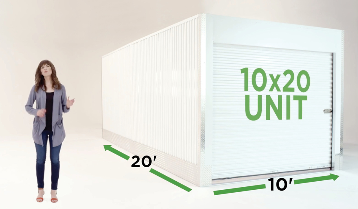 A woman presenting next to a white self-storage unit graphic with green text reading "10x20 UNIT" and dimension arrows indicating 10 feet wide by 20 feet long.