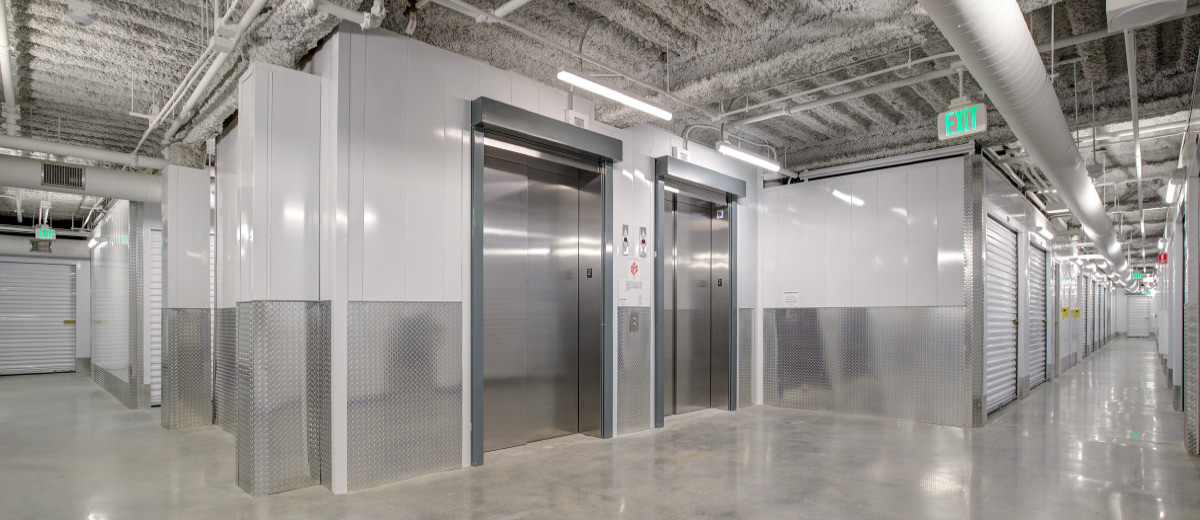 Interior view of two stainless steel elevators in a storage facility.