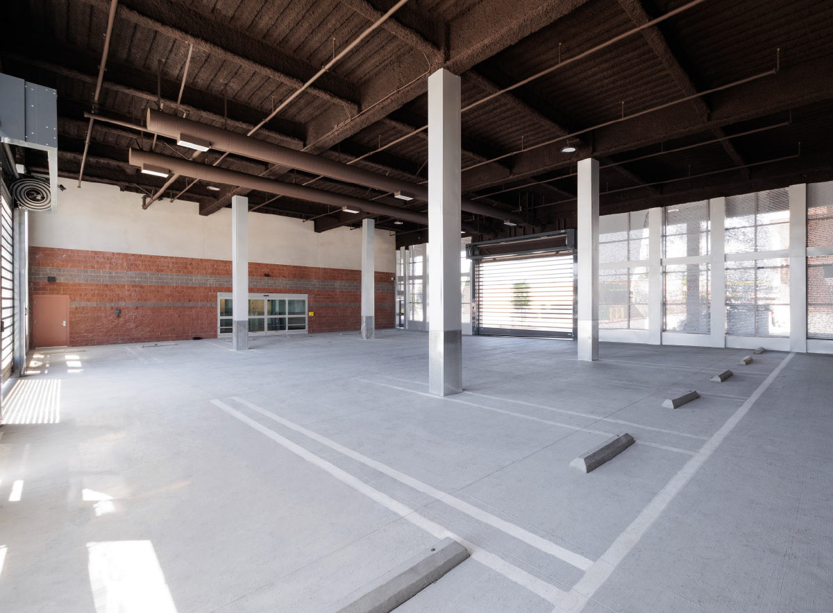 Large covered interior parking and loading area with support columns.
