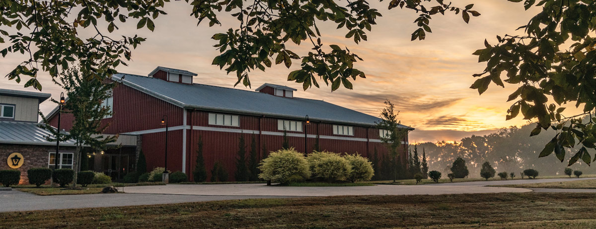 Exterior view of the Atlanta Mission Potter's House campus building at sunset.