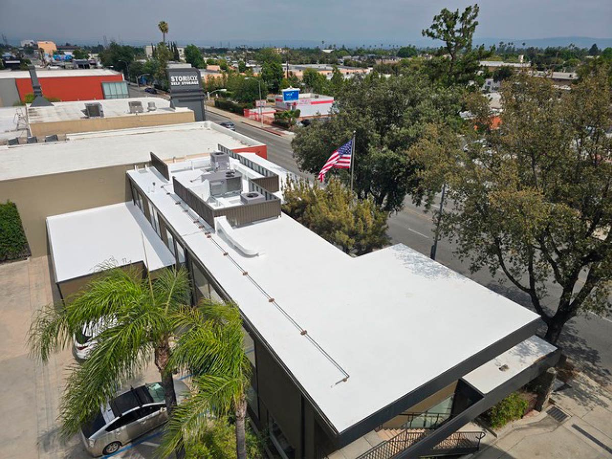 Aerial View Of A Commercial Building With A Newly Installed White SPF Roof Coating.