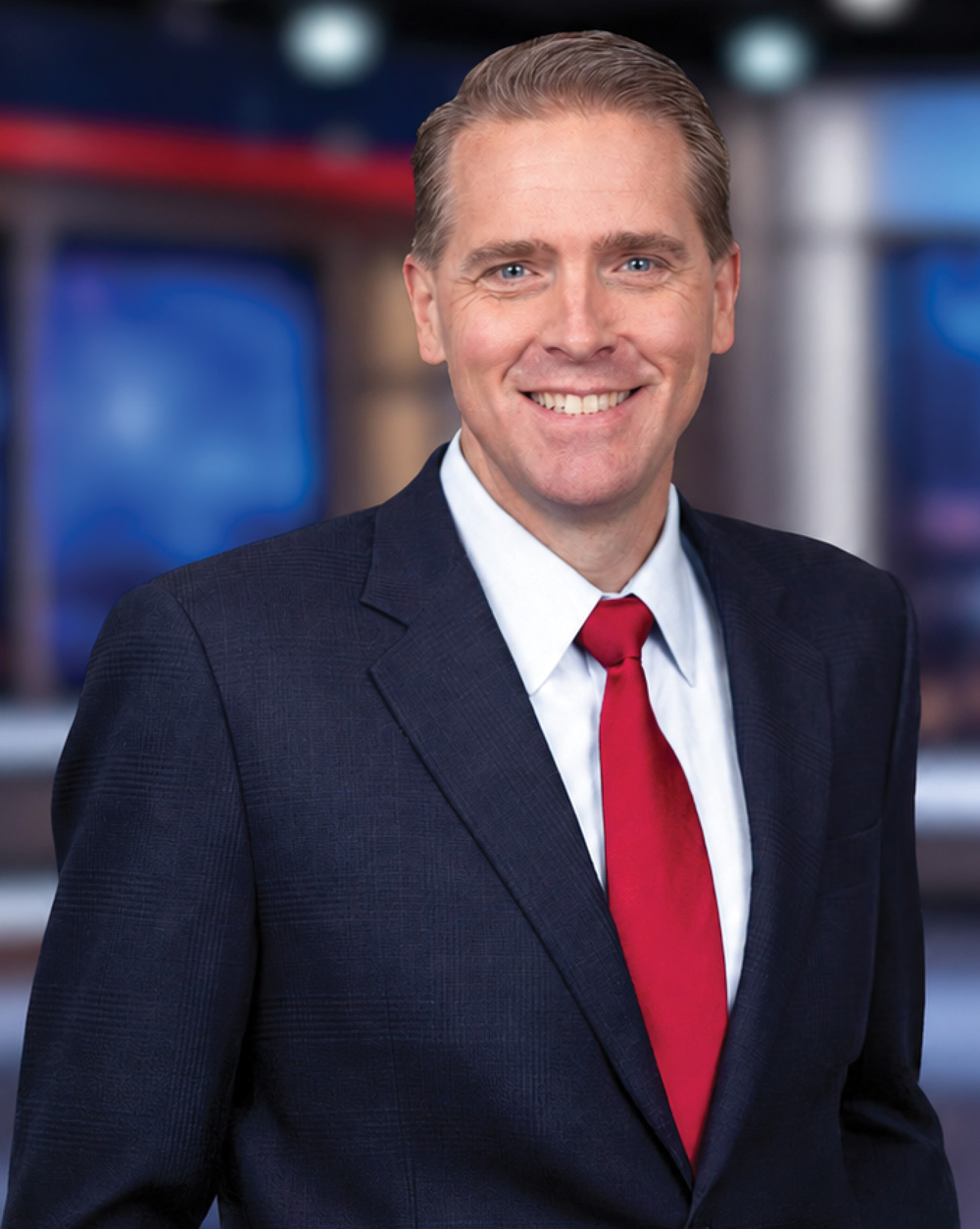 Political commentator Scott Jennings in a suit and tie in a television studio.