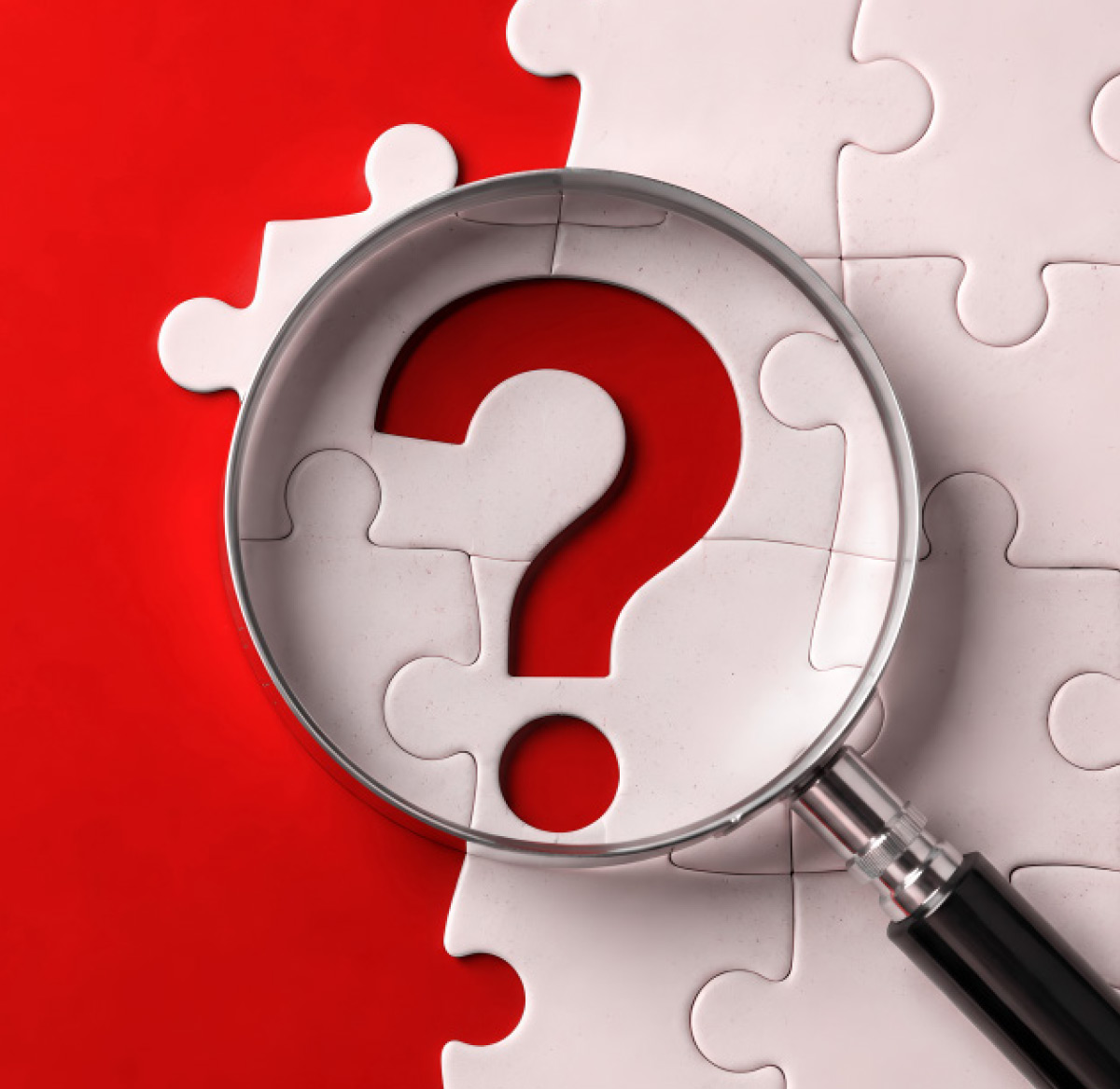 A magnifying glass focuses on a large question-mark-shaped cutout in a white jigsaw puzzle, revealing the red background underneath.
